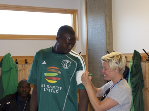 DU Coach Ambassador Margo Baker places the makeshift captain's badge on Khamis.