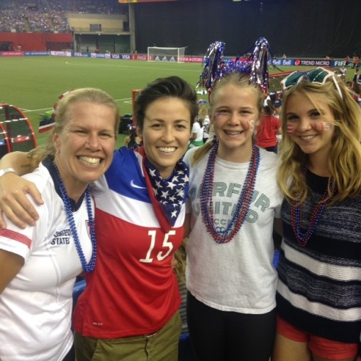 "Dr." Alex Nuttall-Smith and Rachael Rapinoe, both recipients of the DU Spirit Award, at the Women's World Cup in June 2015 with Ella and Julia Nuttall-Smith.